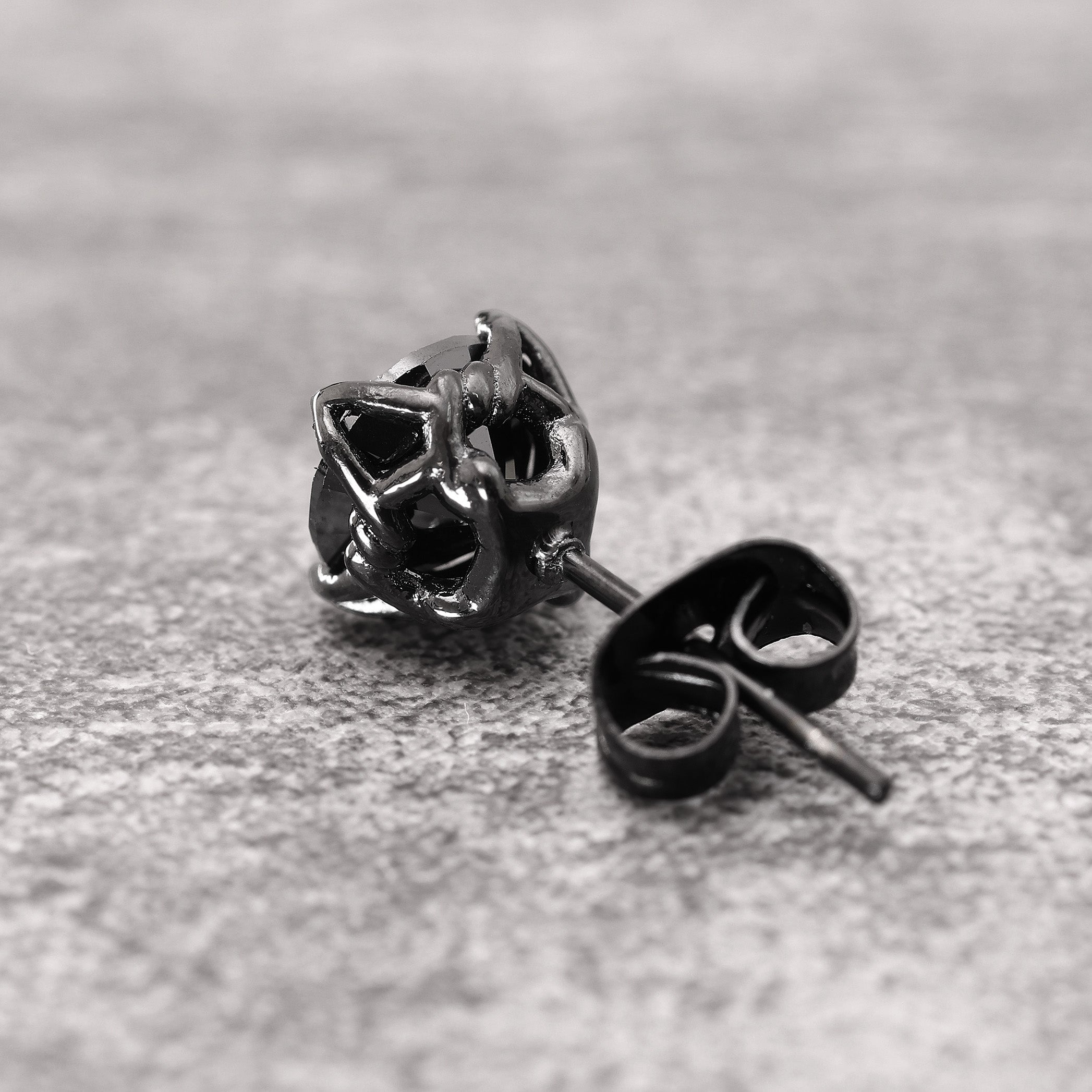Close-up of Black Rhodium Plated Crystal Stud Earring showing black zircon stone and angular geometric cut