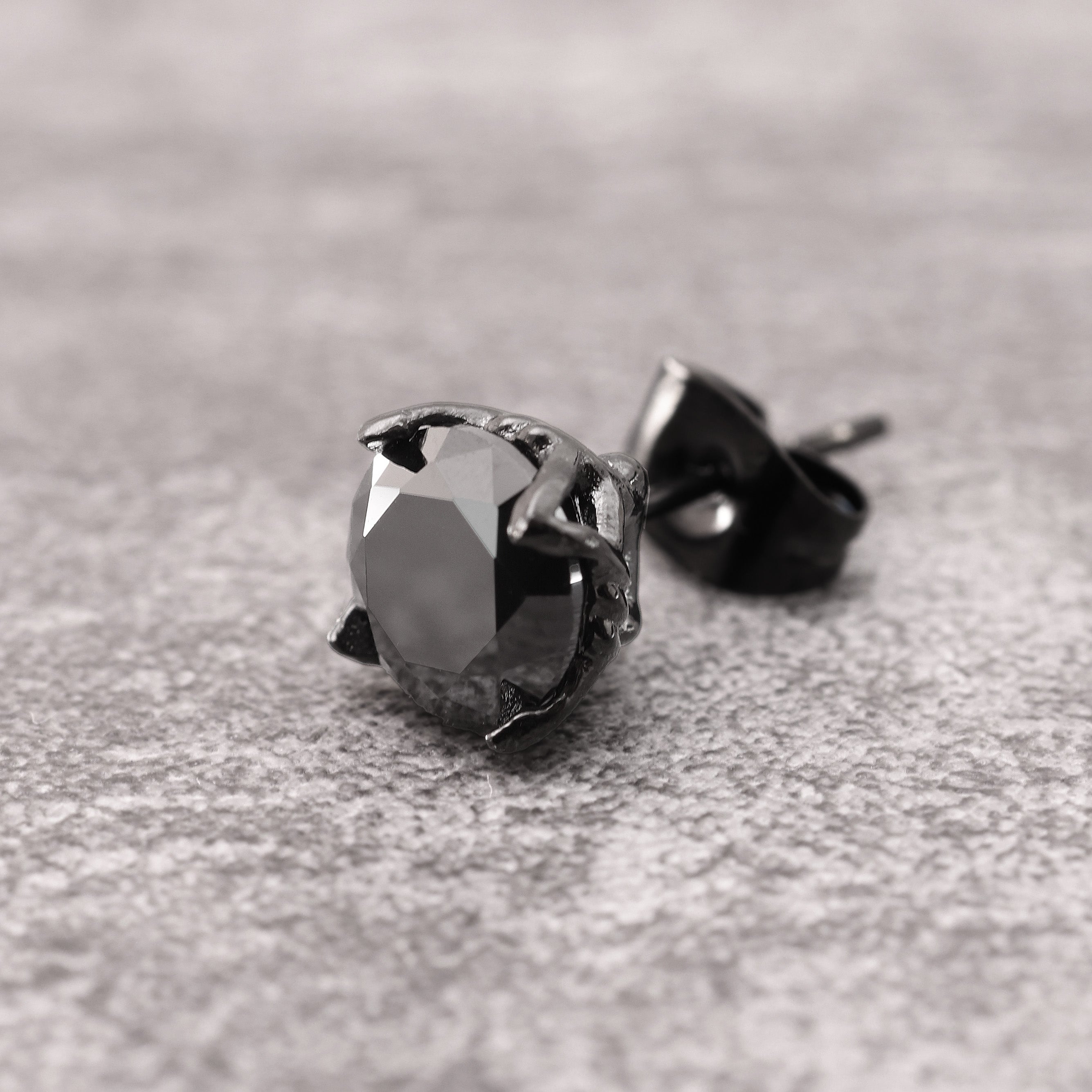 Close-up of Black Rhodium Plated Crystal Stud Earring showing black zircon stone and angular geometric cut