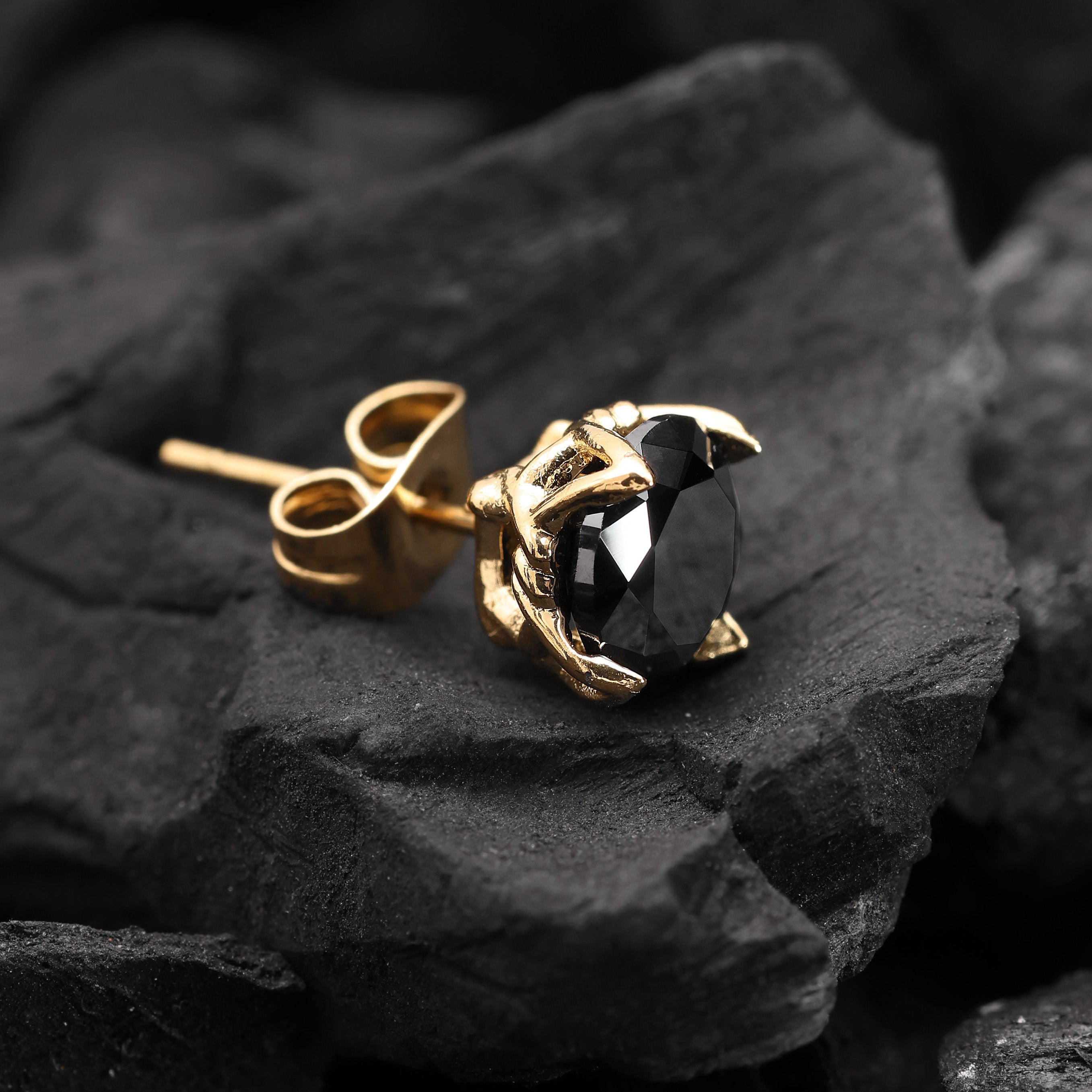 Close-up of Gold Plated Crystal Stud Earring showing black zircon stone with angular precision-cut facets
