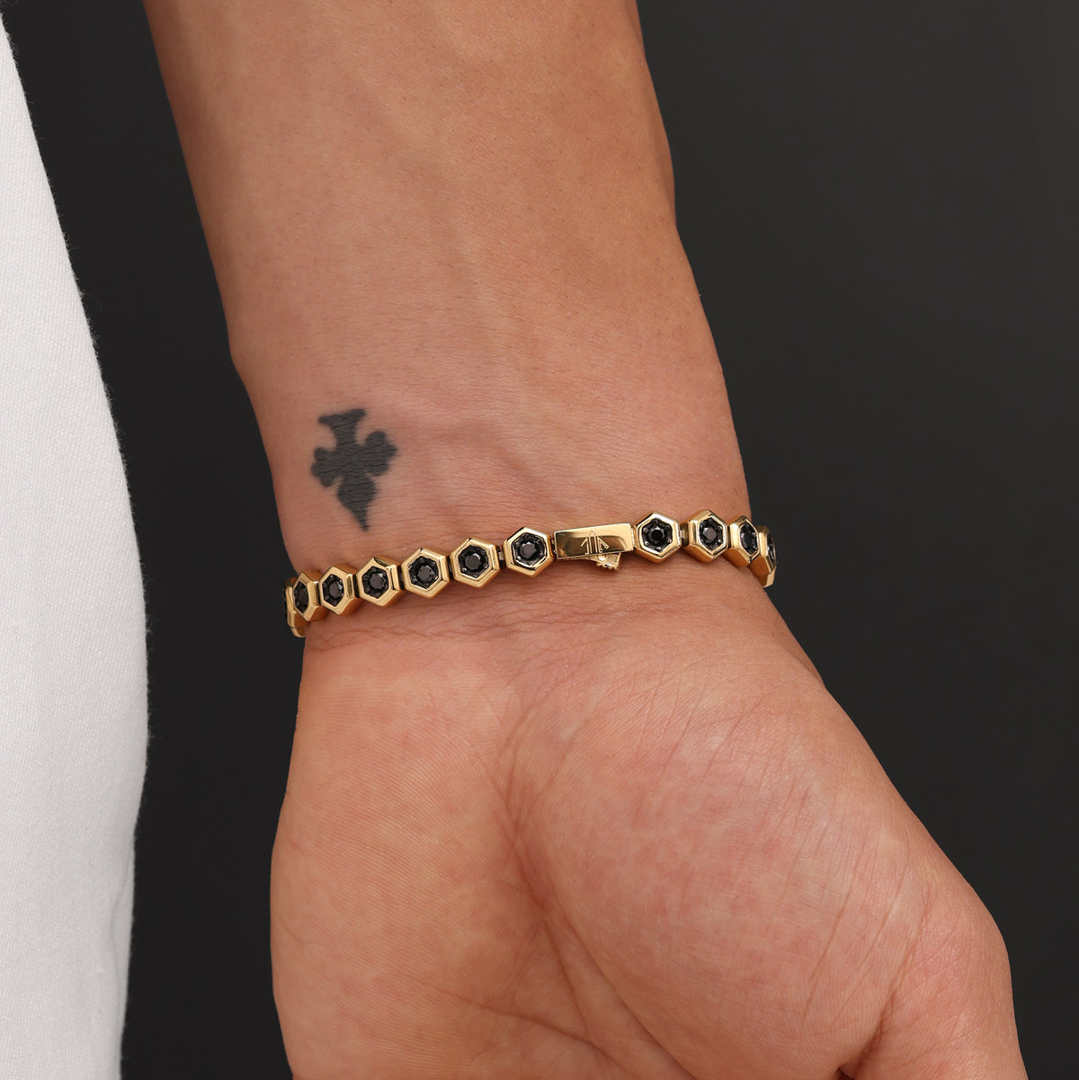 Close-up of 18K Gold Plated Hex Tennis Bracelet showing AAA+ black zircon stones, signature prong-set links, and polished gold finish