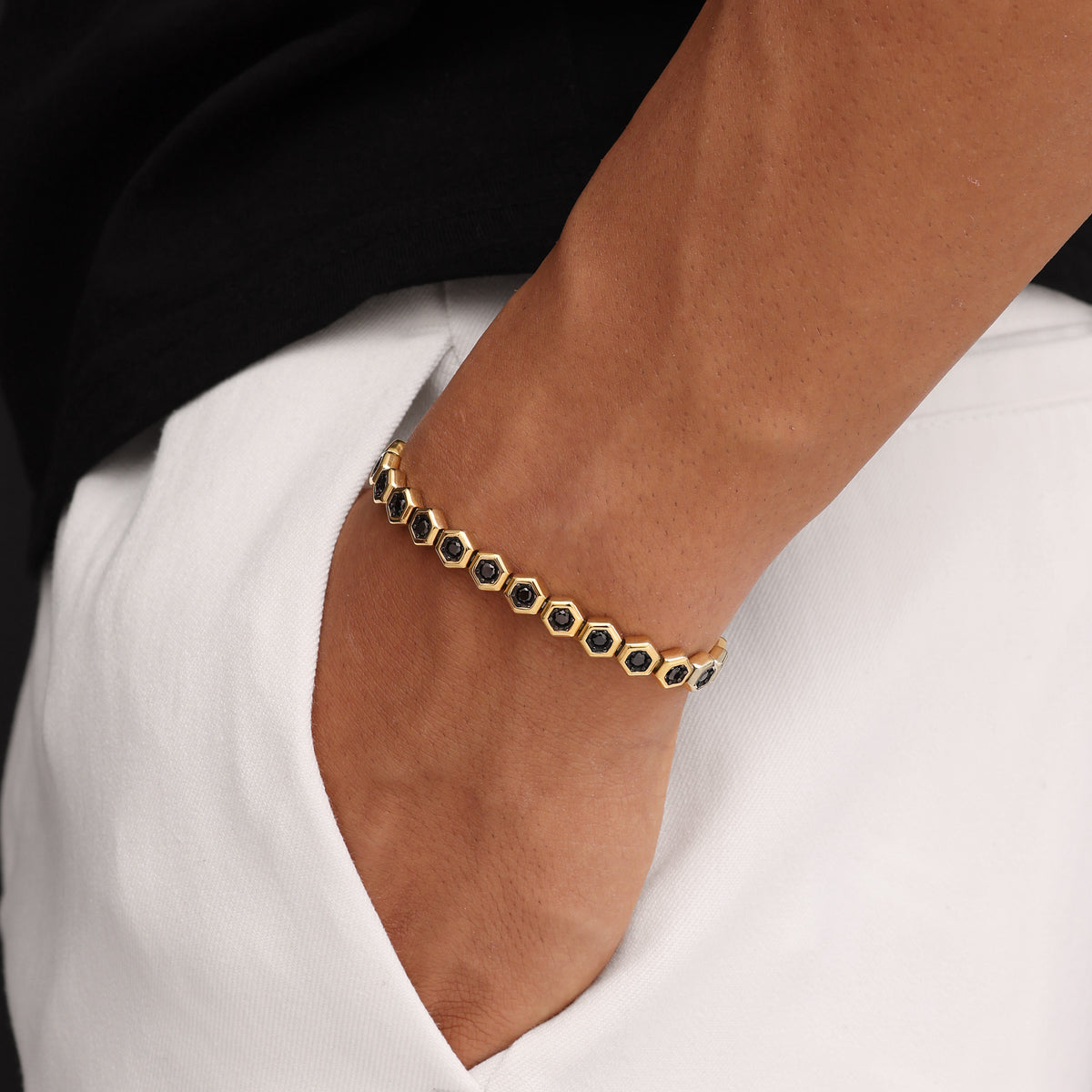 18K Gold Plated Hex Tennis Bracelet 7.5mm with Black Zircon worn on wrist premium men’s luxury tennis bracelet lifestyle view