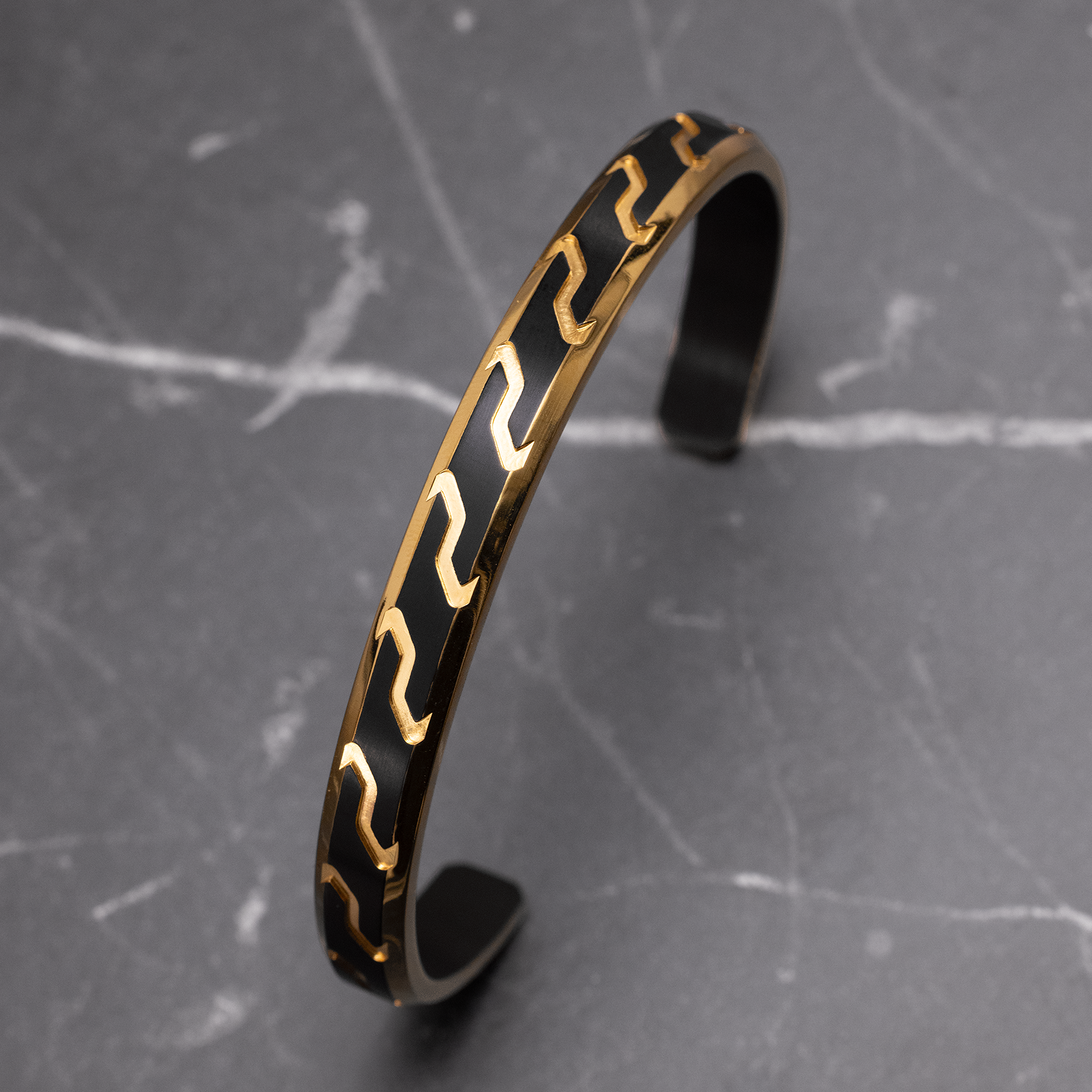 Close-up of Julivno cuff bracelet 8.5mm highlighting Black Rhodium Plated surface and 18K Gold accents