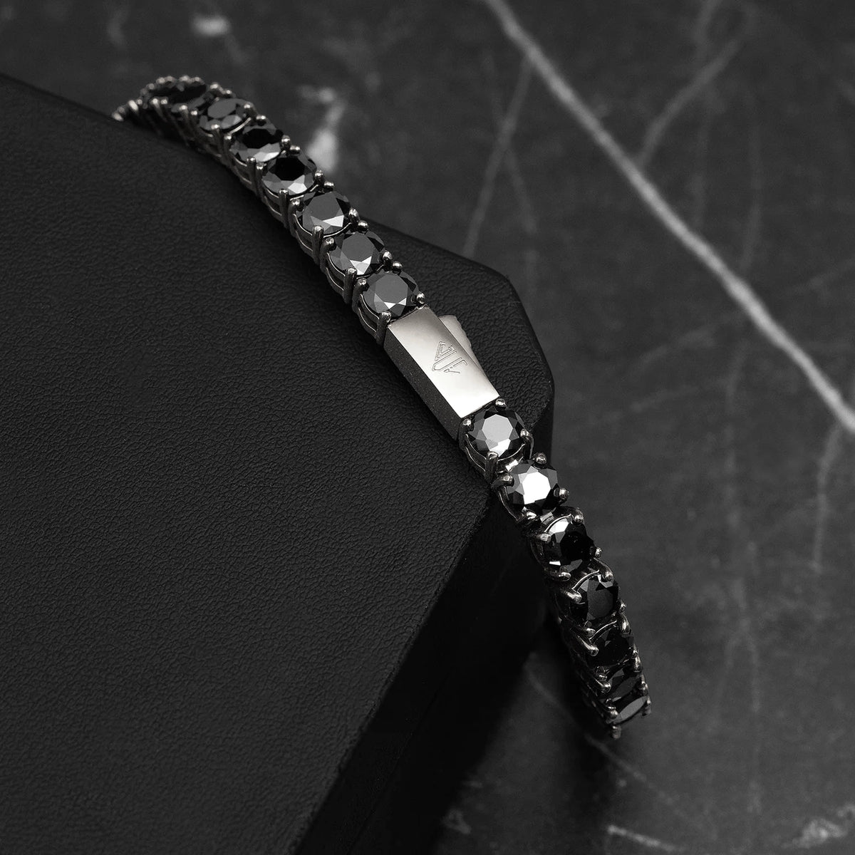 Close-up of Platinum Plated Tennis Bracelet showing black zircon stones, precision prong settings, and polished platinum finish