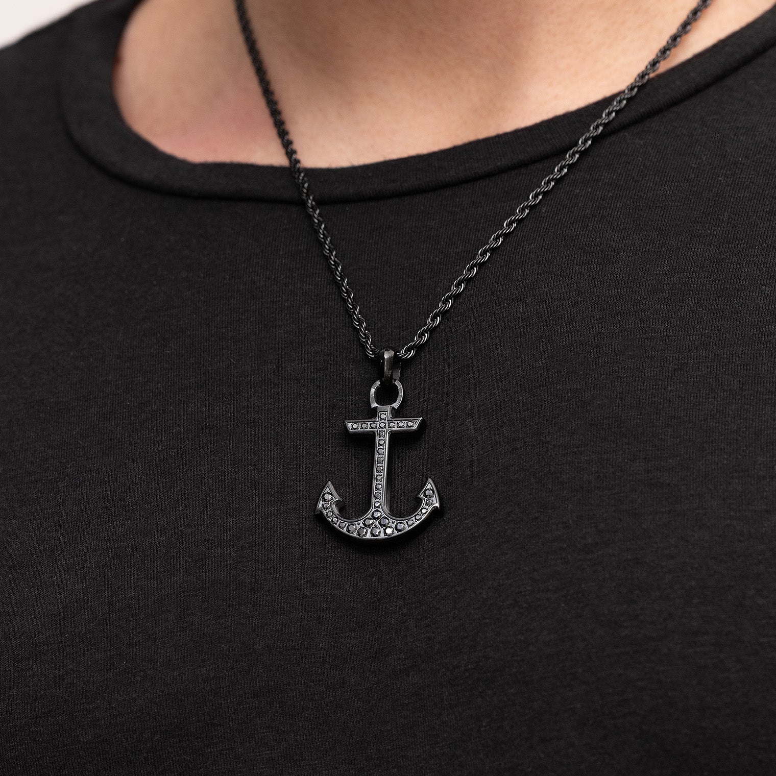Black anchor pendant necklace on a black shirt