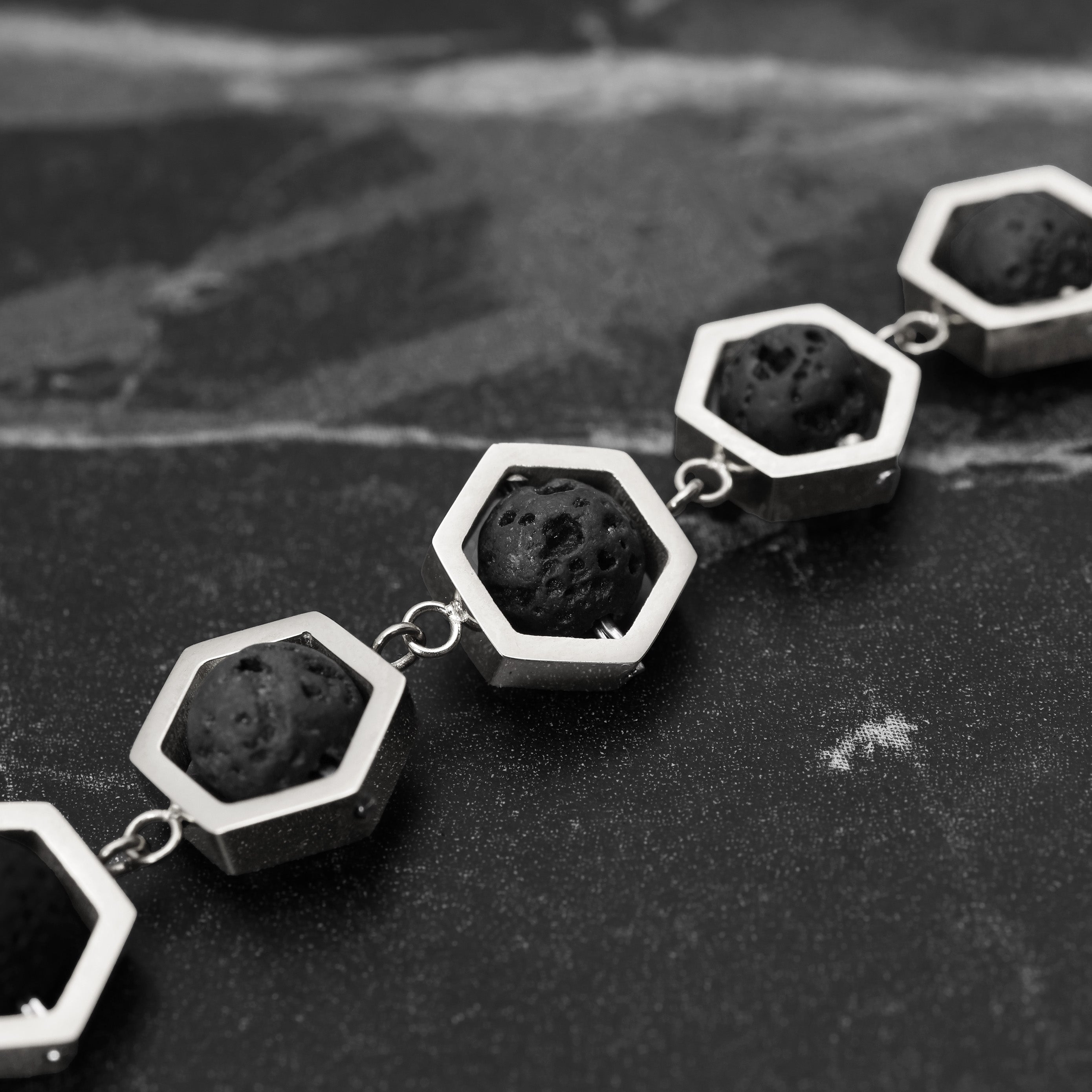 Close-up of Platinum Plated Hex Lava Bracelet showing black volcanic lava beads within hexagon frames