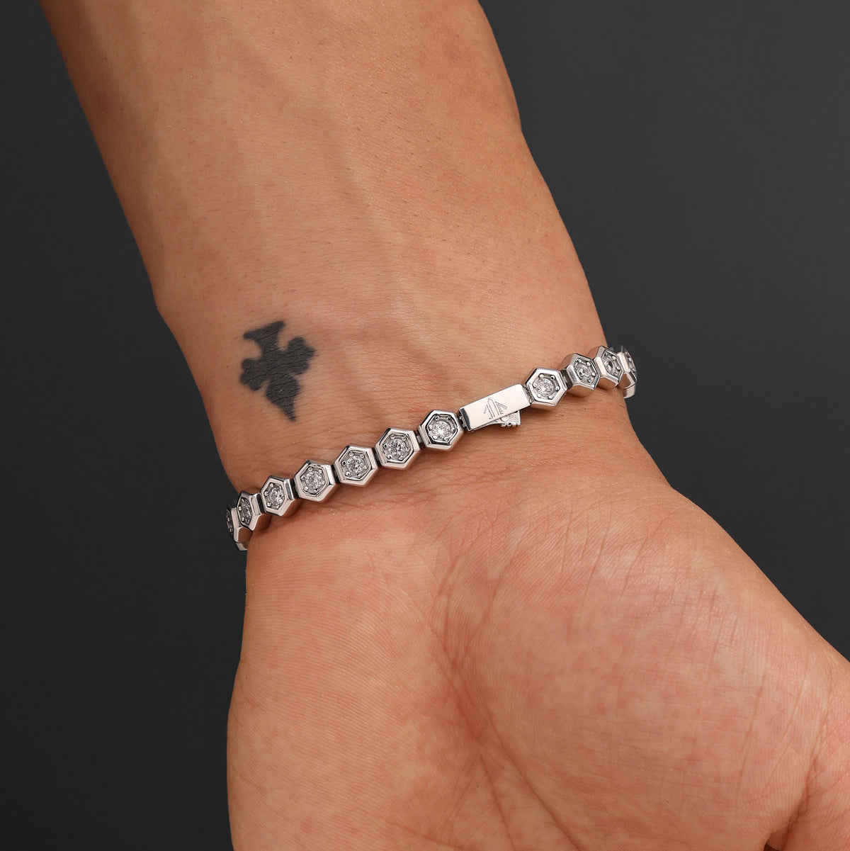 Close-up of Platinum Plated Hex Tennis Bracelet showing AAA+ white zircon stones, signature prong-set links, and polished platinum finish