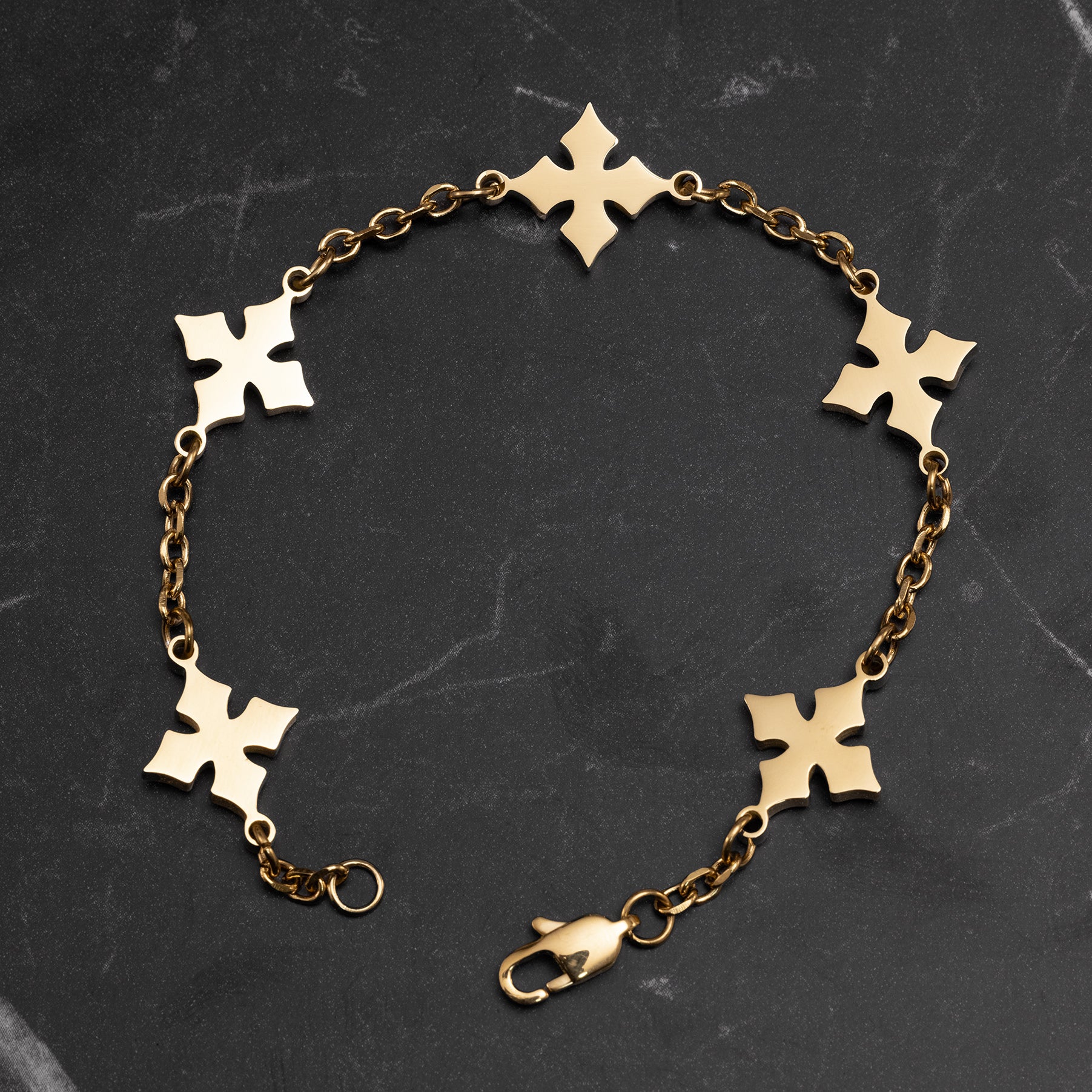 Gold chain bracelet with a clasp on a white background