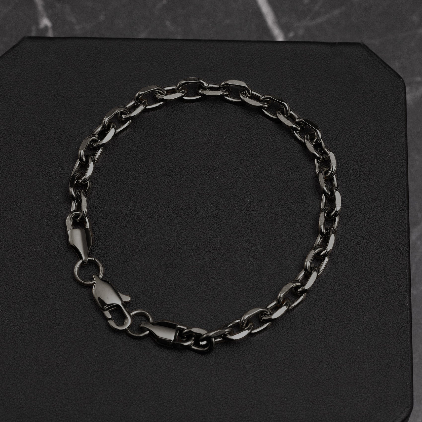 Black chain bracelet on a black background